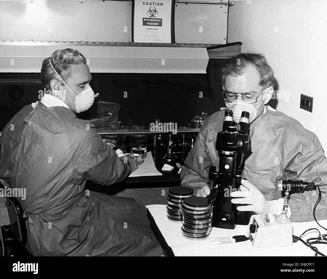 Scientists George Gorman (left) and Jim Feeley in 1978, examining culture plates on which the first environmental isolates of Legionella pneumophila had been grown. The causative agent of Legionnaires' disease, this bacteria was discovered when it became responsible for an outbreak at a Philadelphia convention of the American Legion in 1976. Stock Photo