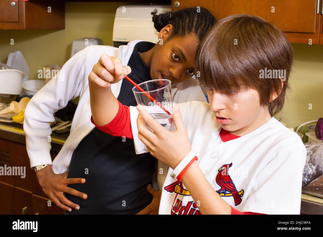 Education Elementary or Middle School Grade 6 science class DNA extraction boy and girl working on experiment Stock Photo