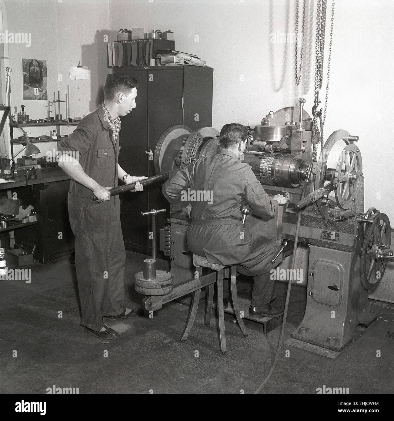 Producing postage stamps in the 1950s. A man with the machine that makes the printing cylinder that later will be used to print the stamps of the new Gustaf Adolf stamps. A total of 340 stamp engravings are fitted onto the cylinder in negative.  Sweden 1951 Kristoffersson ref bc45-3 Stock Photo