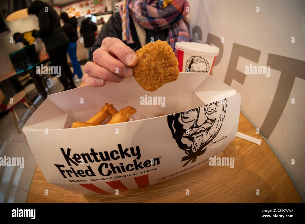 A Woman Enjoys A Combo Order Of Beyond Fried Chicken At A Kfc In Midtown Manhattan On Its Launch 