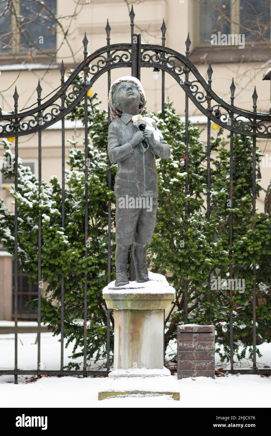 Romain Gary bronze statue of a boy clutching a galosh and looking to the sky made by lithuanian artist Romualdas Kvintas, vertical Stock Photo