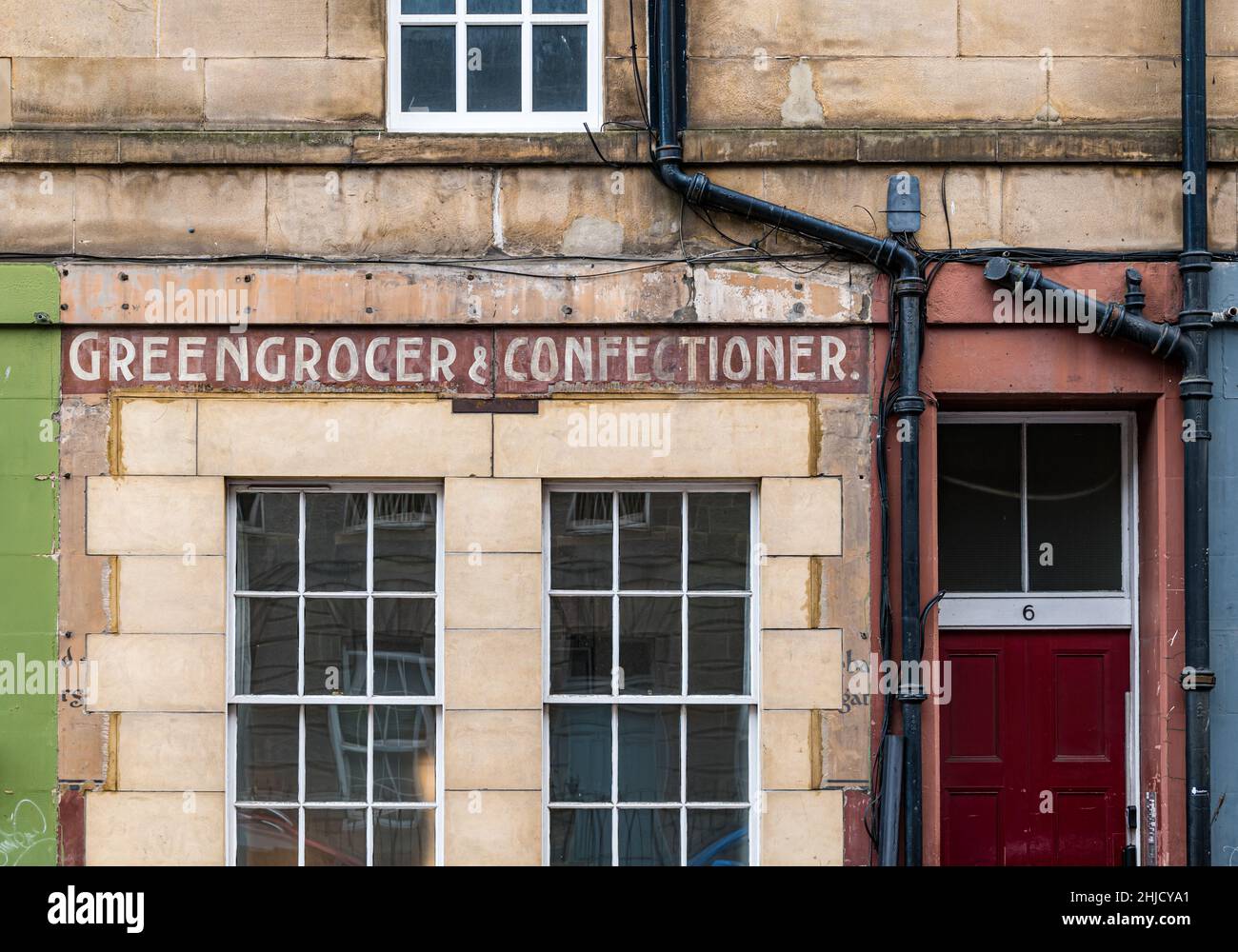 Old greengrocer and confectioner shop sign on restored Leith building, Edinburgh, Scotland, UK Stock Photo