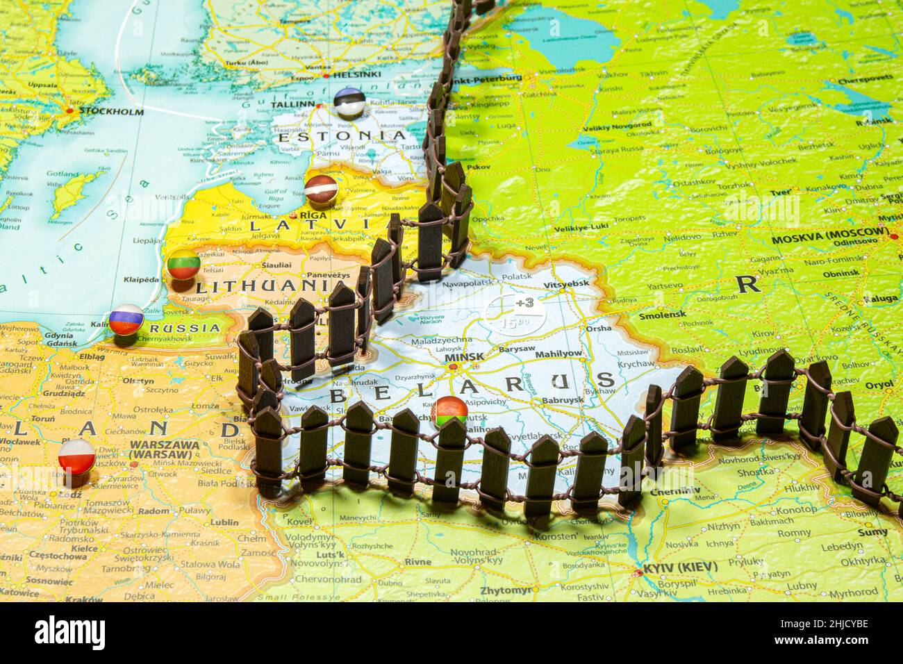 Concept of common border Russia and Belarus. Fence separating from European countries NATO Latvia Lithuania and Estonia. Close up picture on a colorfu Stock Photo