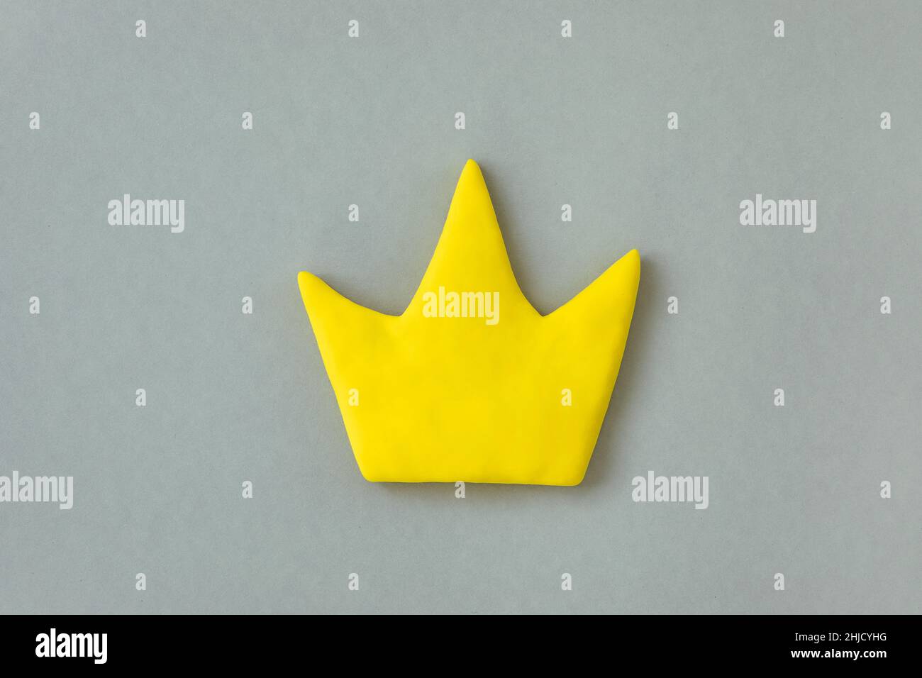 Simple 3d yellow crown symbol on gray background. Concept of win and success, top rank quality status. Stock Photo