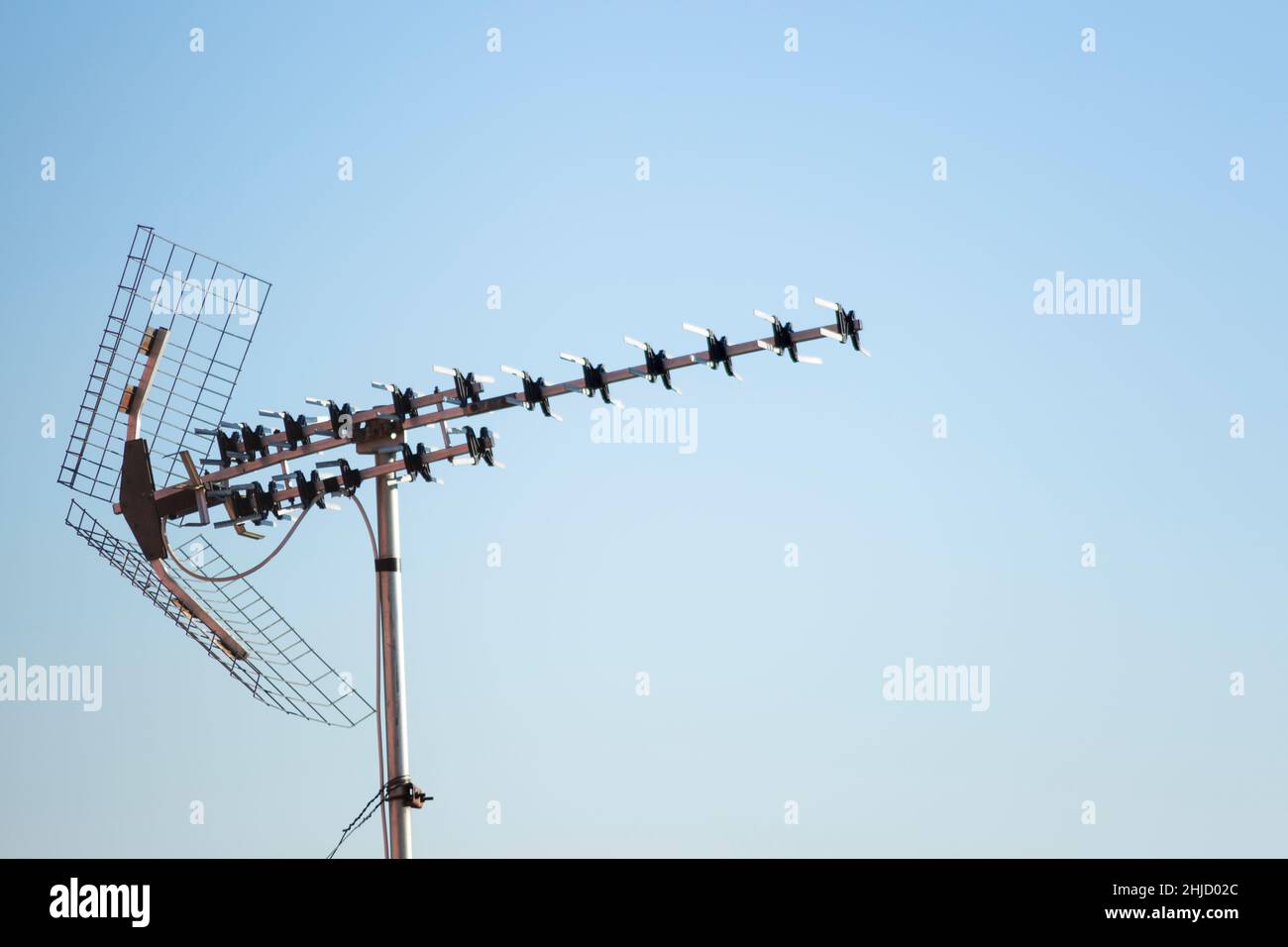 TV antenna on blue sky background Stock Photo - Alamy