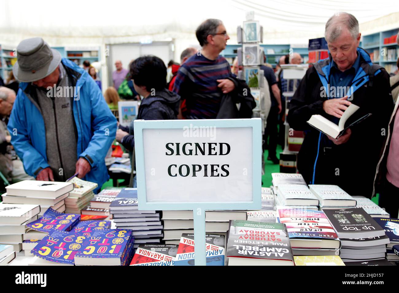 Hay Festival, people look at books by the signed copy stand in the bookshop tent on the 26th of May 2018. Stock Photo