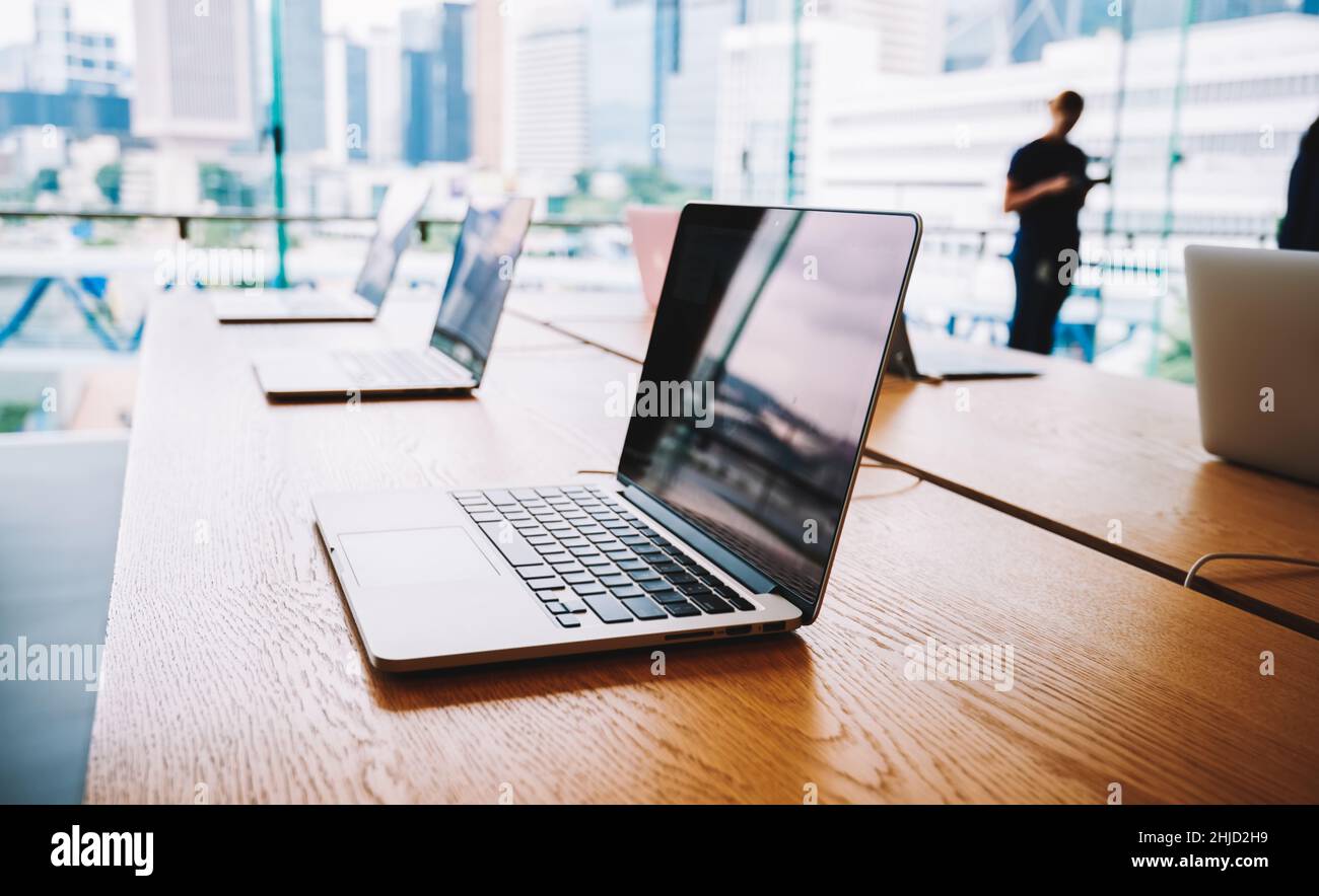 Laptops placed on table in modern office Stock Photo Alamy