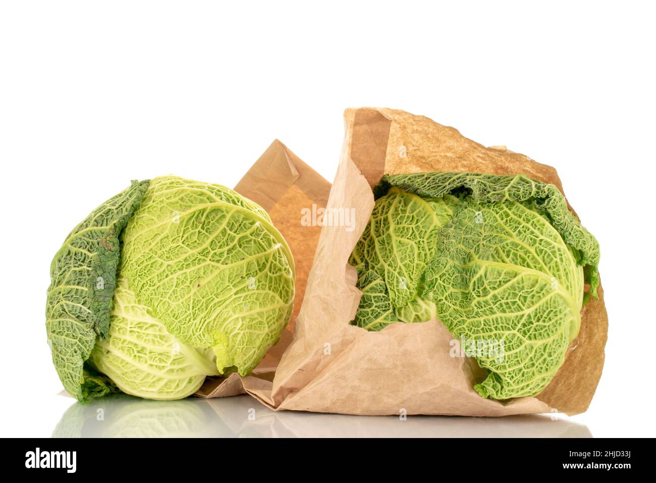 Two bales of organic Savoy cabbage with paper bag, macro, isolated on ...
