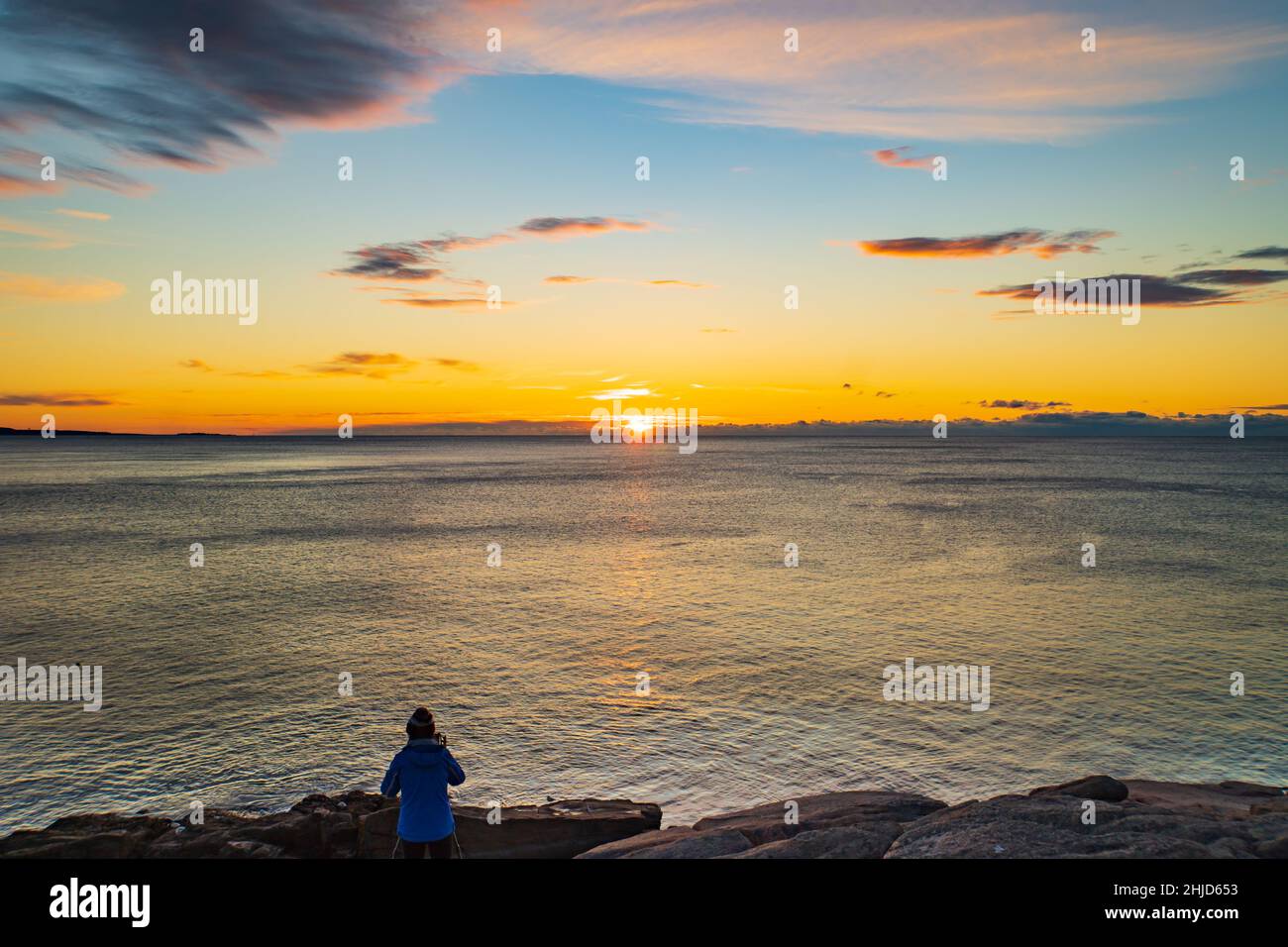 photographer capturing the sunrise on the Atlantic ocean horizon in Acadia National Park, Maine, USA Stock Photo