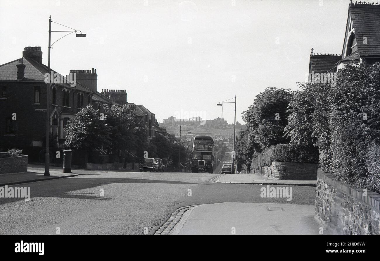 1960, historical, a AEC Regent RT bus, No 233 going up a slight incline on a leafy suburban London street, England, UK. The double-decker bus carried passengers on the Finsbury Park - Muswell Hill (Alexander Park) route. The RT was the standard London bus of the 1950s - and even outnumbered the famous 'Routemaster' bus throughout the 1960s - and for a bus first delirerd in 1939, it remained in service for 40 years until 1979. Stock Photo