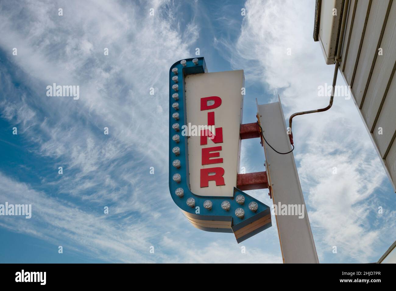 Neon diner sign against a blue sky. Stock Photo