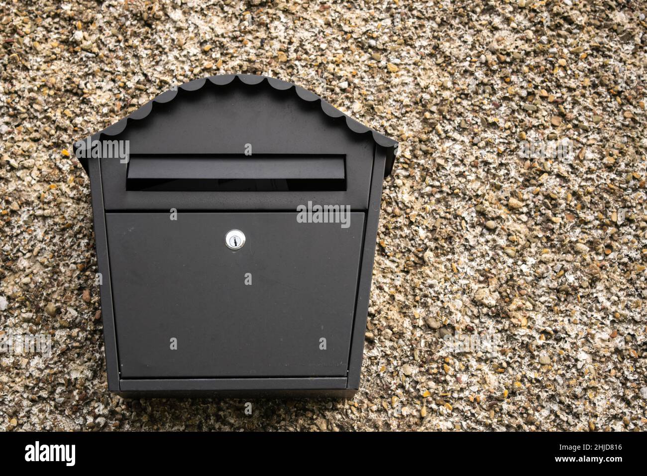 Mailboxes mounted at entry gates, mailboxes embedded in a stone wall