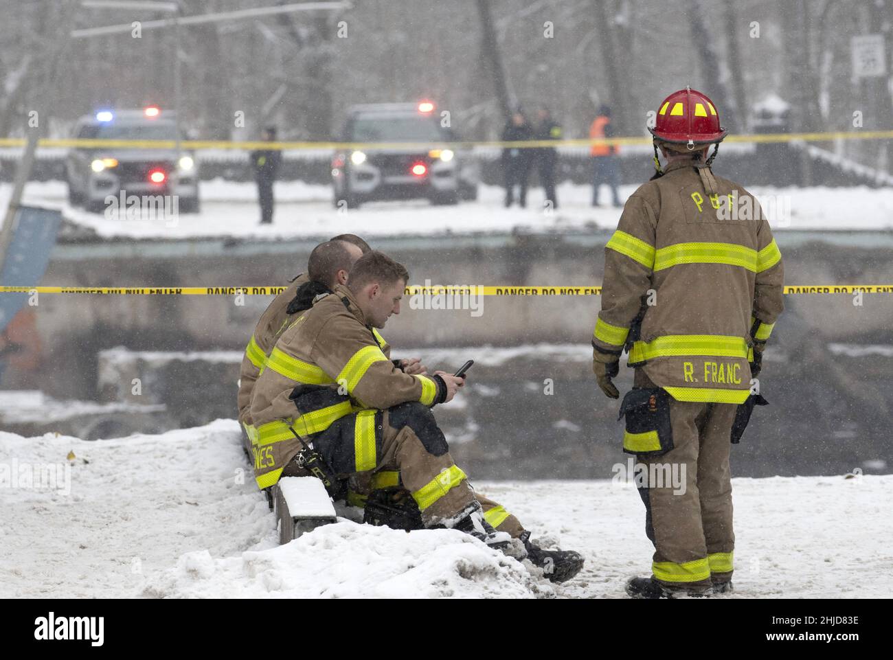 Pittsburgh, United States. 28th Jan, 2022. A members of the Point Breeze Fire Department looks over the edge of the Fern Hollow Bridge collapse in the Point Breeze area of Pittsburgh on Friday January 28, 2022. A bus and several cars were involved, but no fatalities have been reported. Photo by Archie Carpenter/UPI Credit: UPI/Alamy Live News Stock Photo