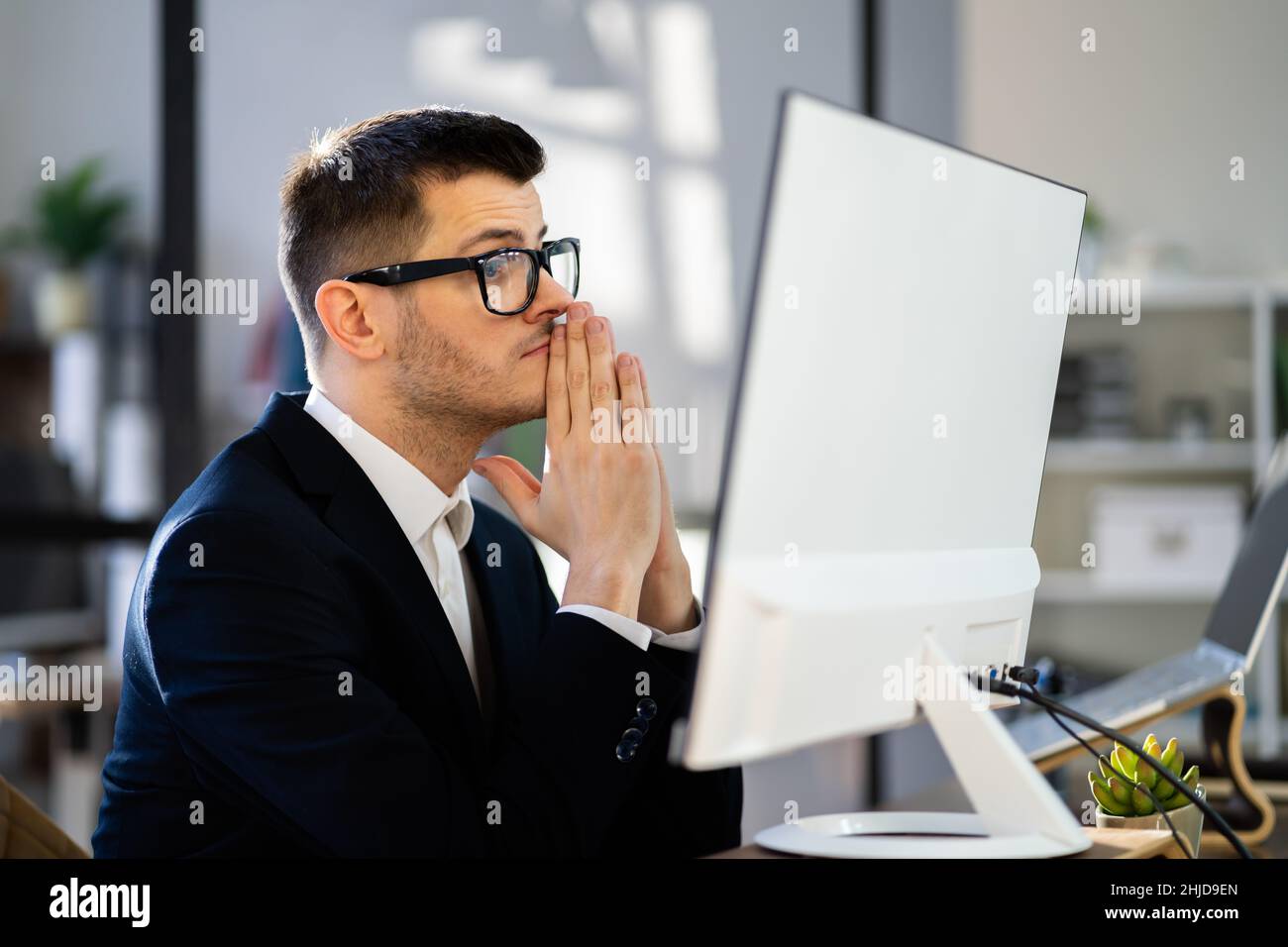 Pondering Thinking Businessman Using Office Computer. Contemplative Man Stock Photo