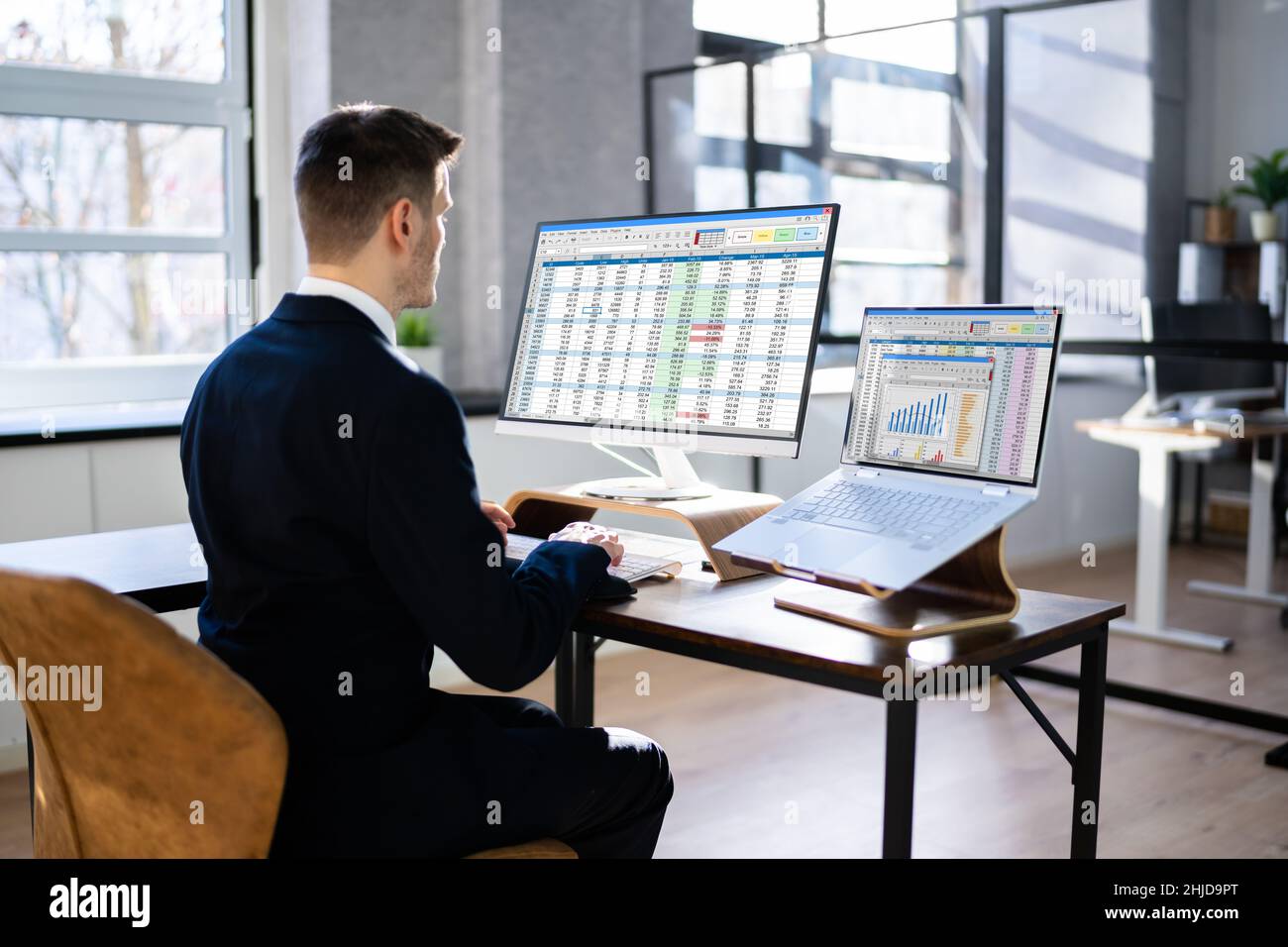 Analyst Working With Spreadsheet Business Data On Computer Stock Photo