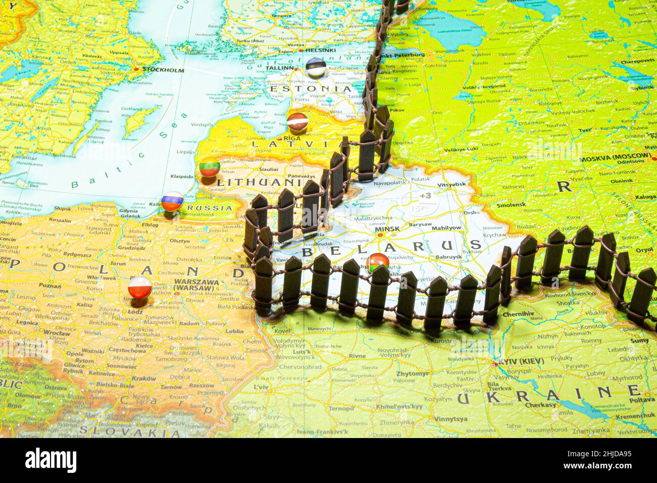 Concept of common border Russia and Belarus. Fence separating from European countries NATO Latvia Lithuania and Estonia. Close up picture on a colorfu Stock Photo