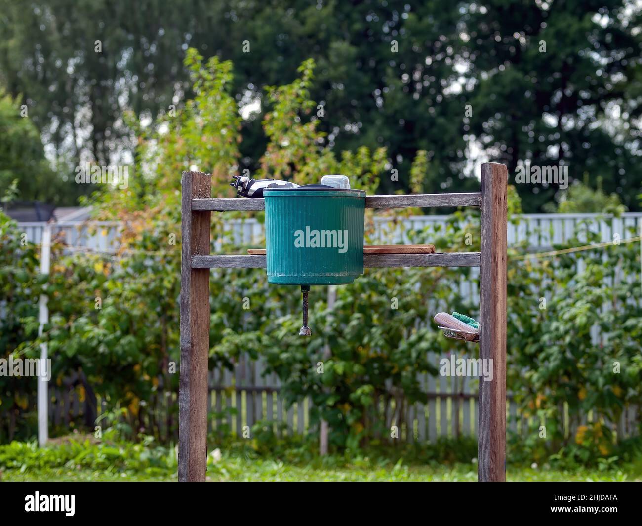 green plastic washbasin in the village, in summer Stock Photo