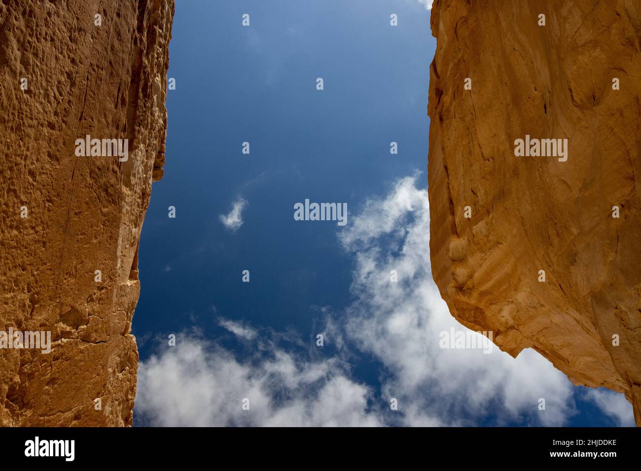 Looking up through two sandstone rocks towards the blue sky in the ...