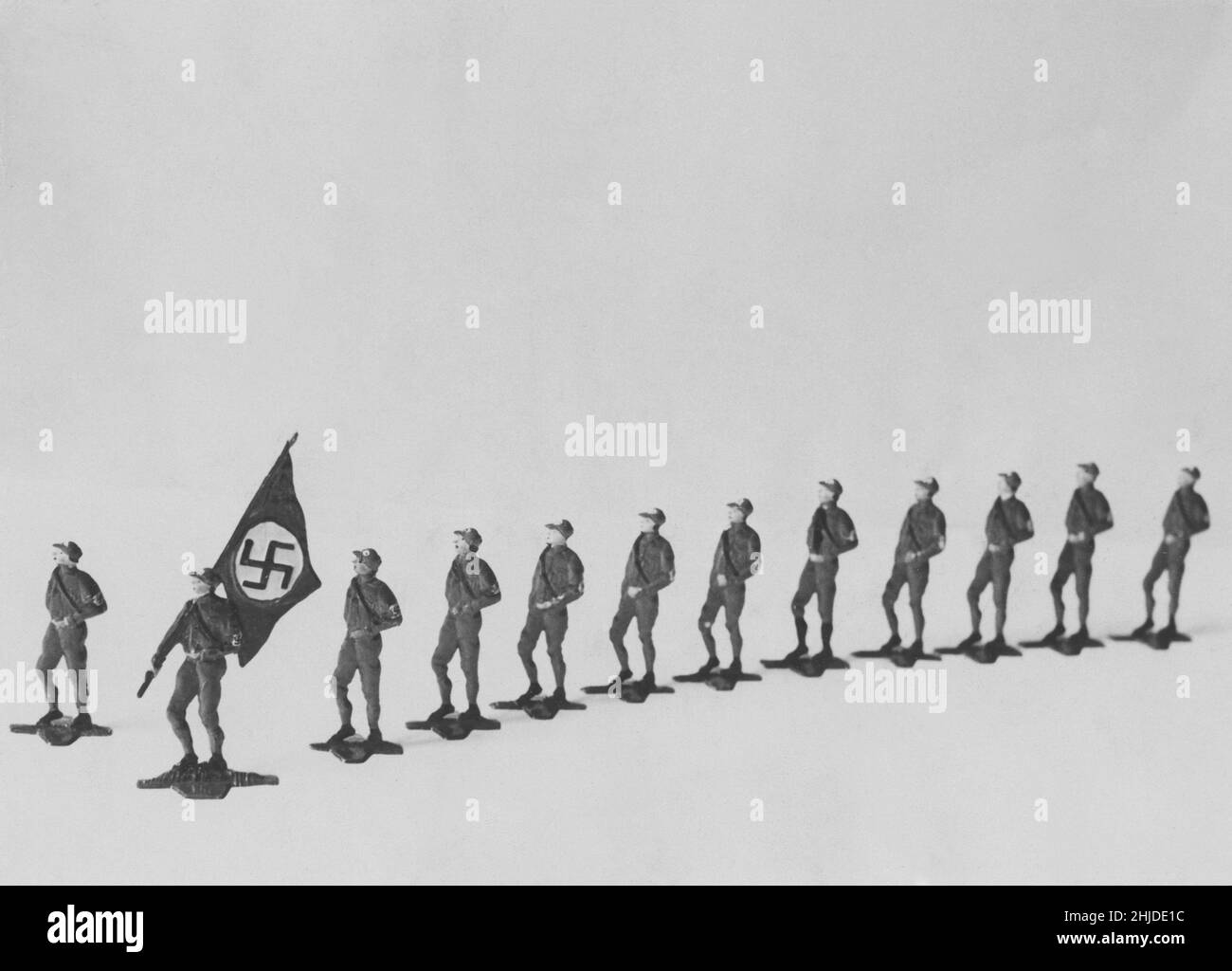 Tin soldiers in the 1930s. German tin toy soldiers wearing uniforms and carrying the nazi flag. Stock Photo