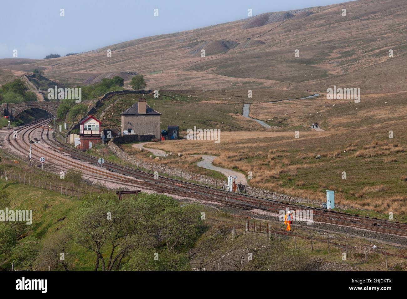 The signalman at Blea Moor signal box  (north of Ribblehead viaduct) sets off on the long walk back to civilization after the evening shift change. Stock Photo