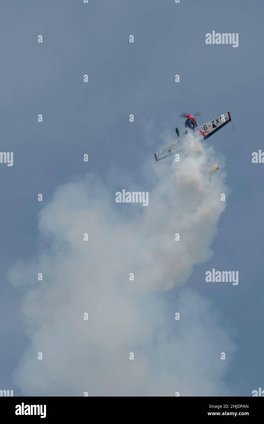 Extra EA-300/L acrobatic plane falling from top of loop Stock Photo