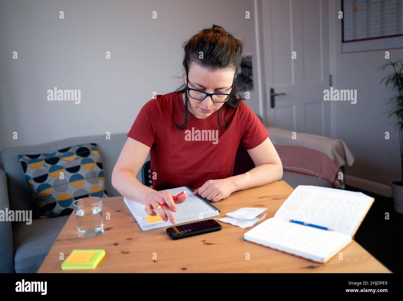 January 4th 2021: London, UK: Accountant doing paperwork in a home office Stock Photo