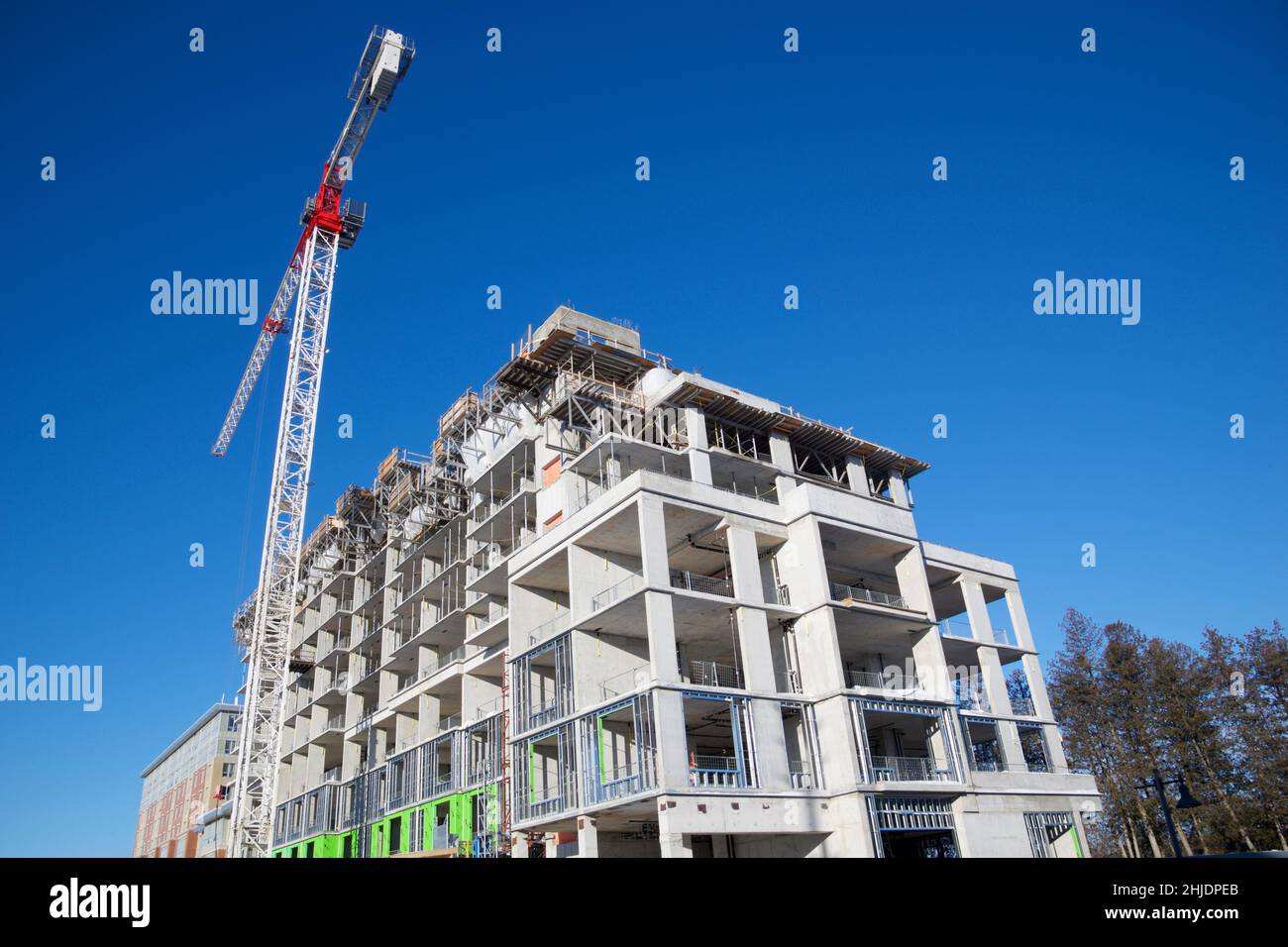 Crane and building construction site with blue sky background Stock Photo