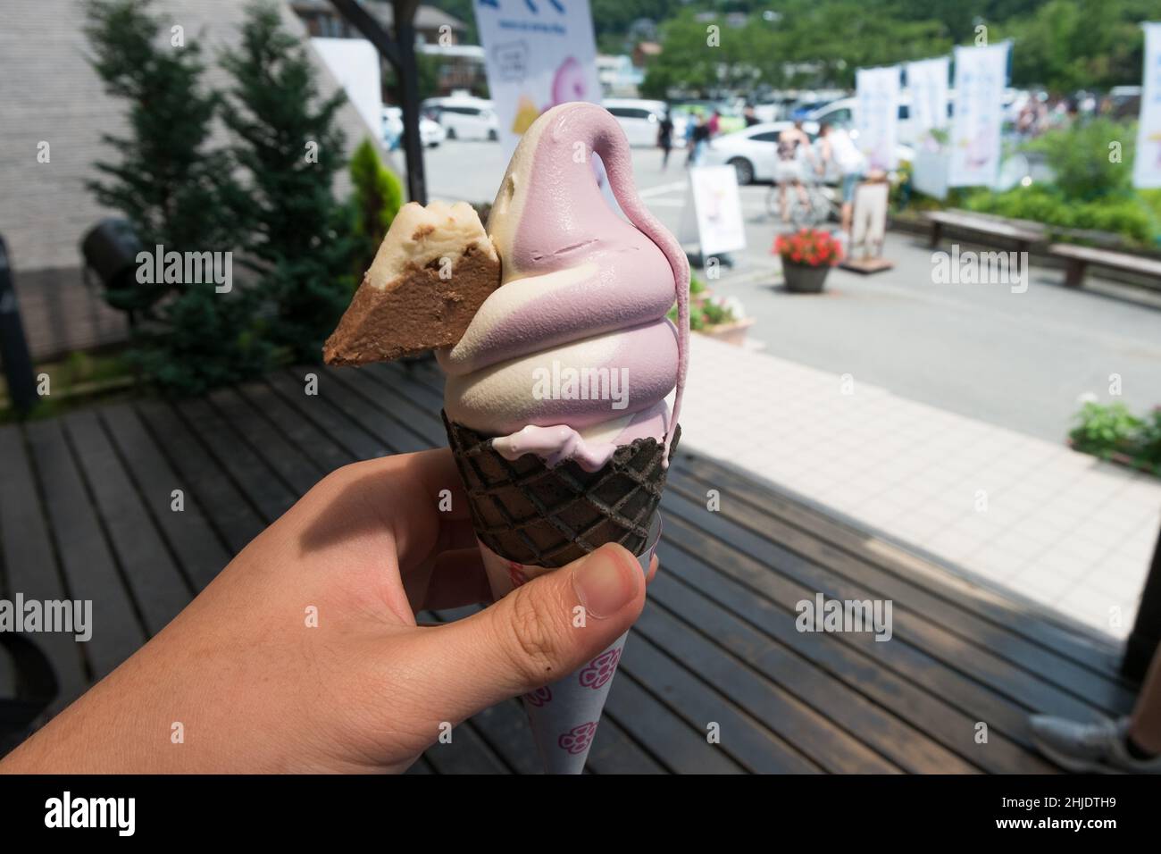 Close up of white and purple soft serve ice cream with cookie shaped like a mountain embedded Stock Photo