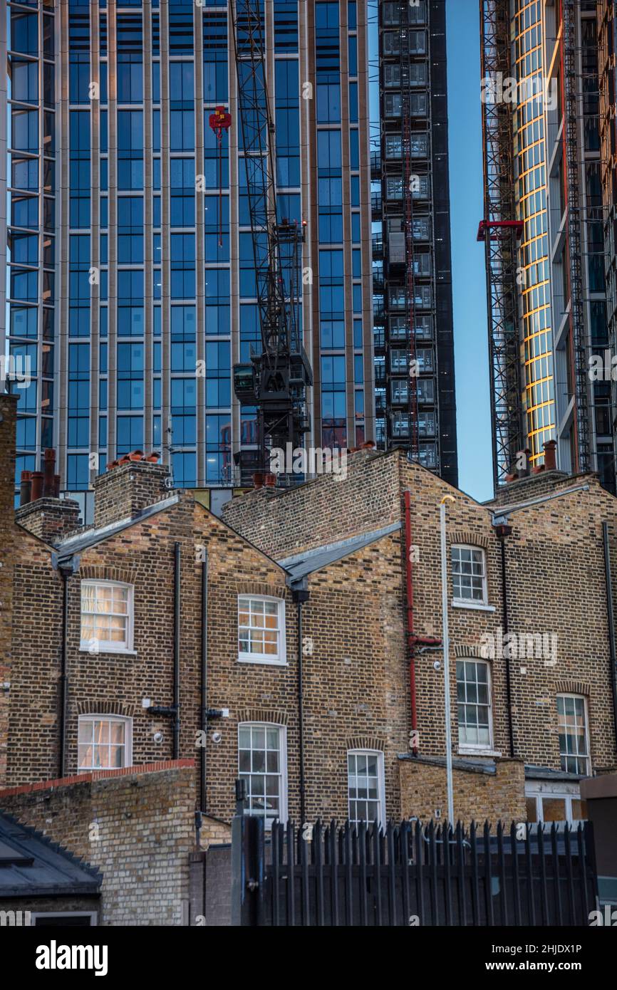 London, Vauxhall, Georgian-style houses and skyscrapers. 18th Century brick town houses with a backdrop of modern skyscrapers under construction Stock Photo