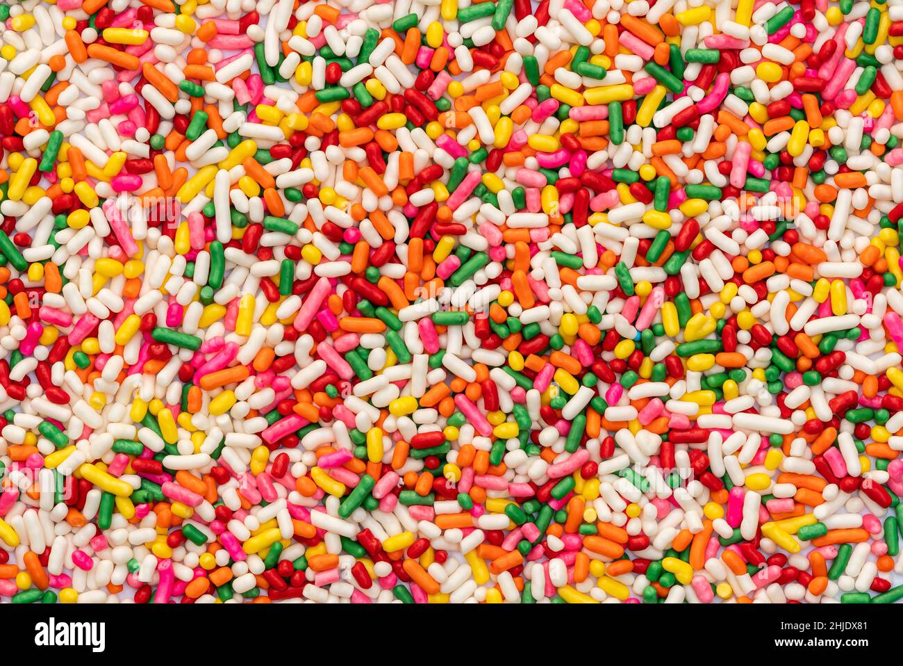 Top view of multicolor rainbow sprinkles. Colorful sprinkles sugar background. Sugar sprinkles is for decoration cake and other bakery items. Stock Photo