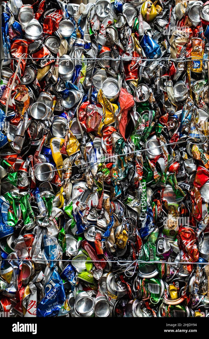 Colourful drink cans are crushed together and prepared for recycling. Stock Photo