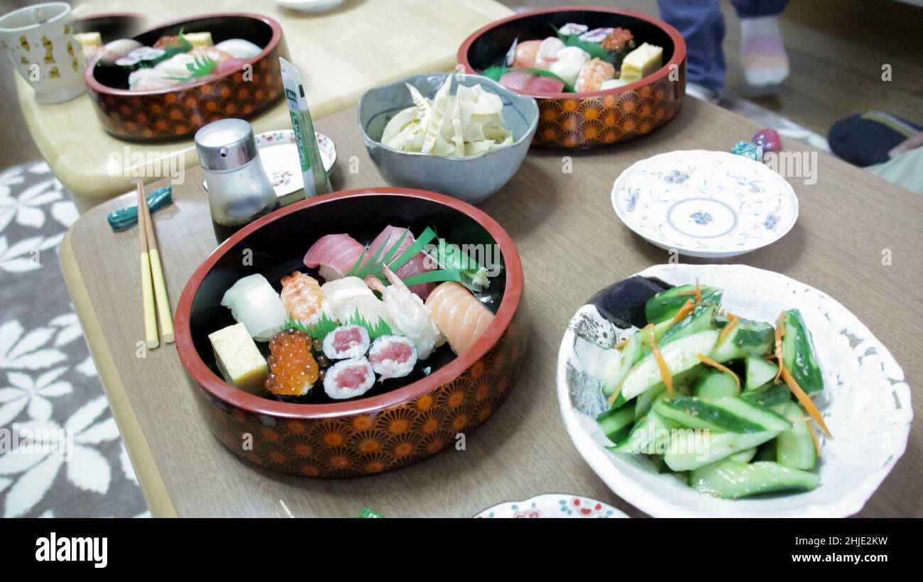 Sushi and sashimi with soya sauce on wooden table in Tokyo Stock Photo