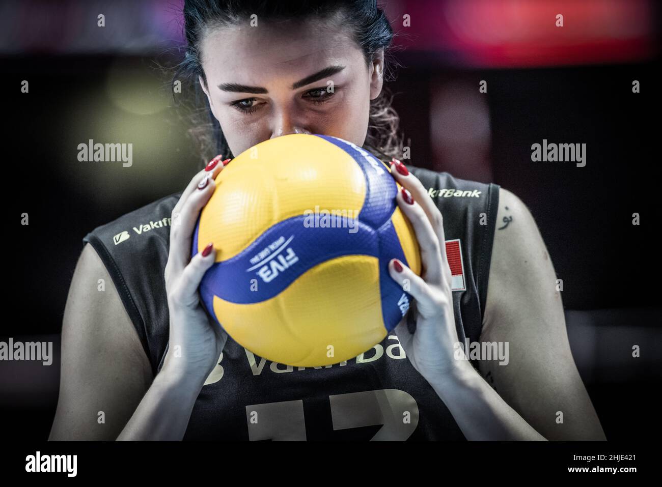 Female player kissing the volleyball for luck at the Volleyball Clubs