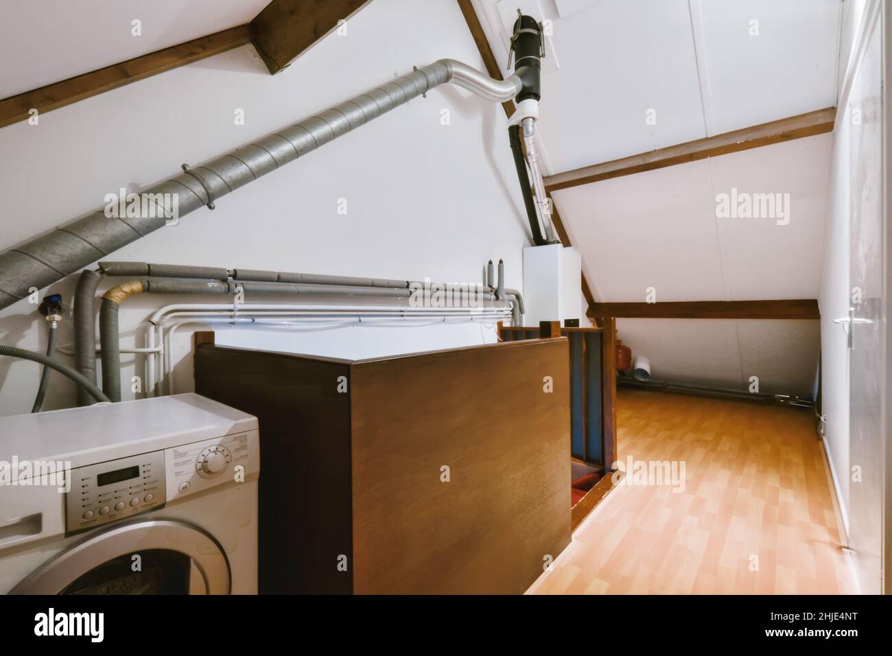 Fascinating laundry room with washing machine and stairs Stock Photo