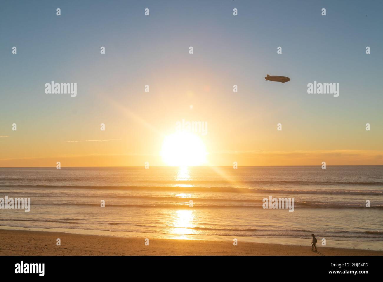 Torrey Pines State Beach La Jolla, California, USA. 28th Jan 2022. January 28, 2022: The sunset at Torrey Pines State Beach La Jolla, California on Friday, January 28th, 2022. The sunset included people, cliffs, rocks, and a blimp. The state beach also had parking for the nearby Farmers Insurance Open golf tournament. (Credit Image: © Rishi DekaZUMA Press Wire) Credit: ZUMA Press, Inc./Alamy Live News Stock Photo