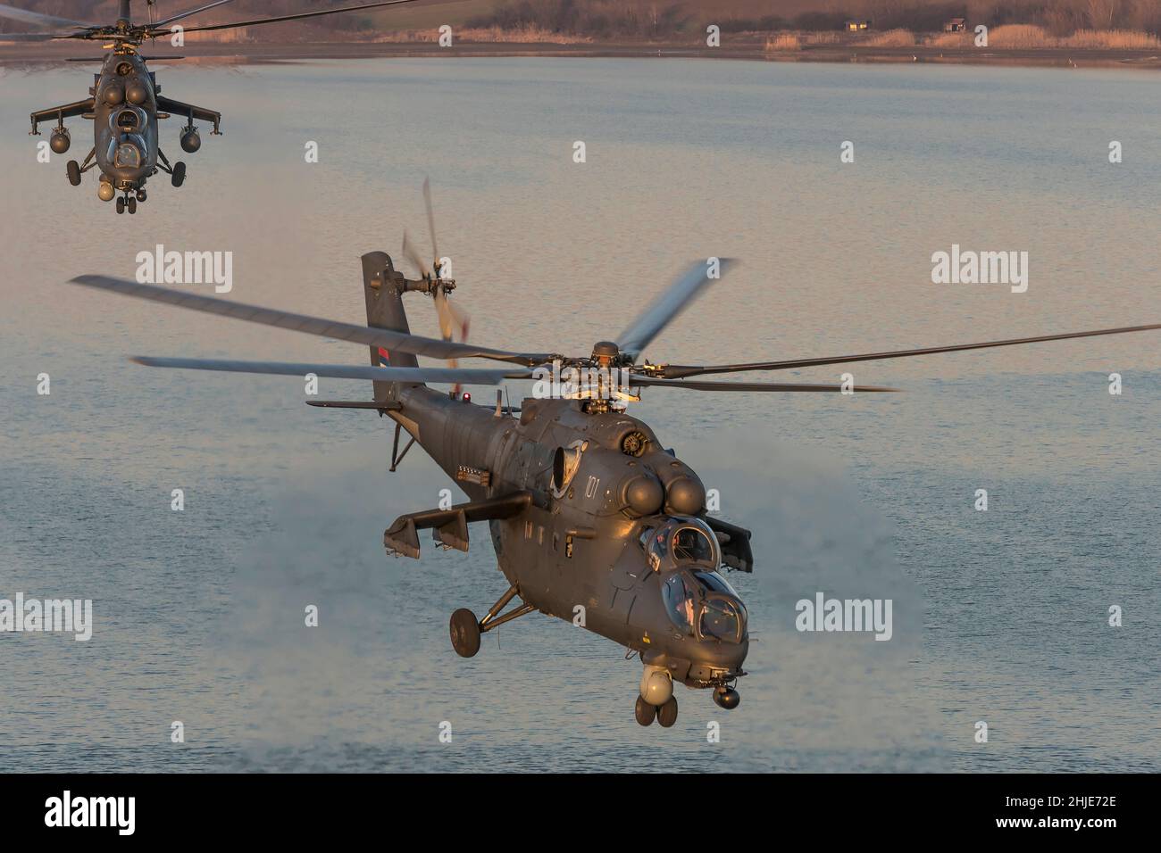 Serbian Air Force Russian Helicopters Mil MI/35M *NATO reporting name: Hind) combat helicopters gunships in flight over water Stock Photo