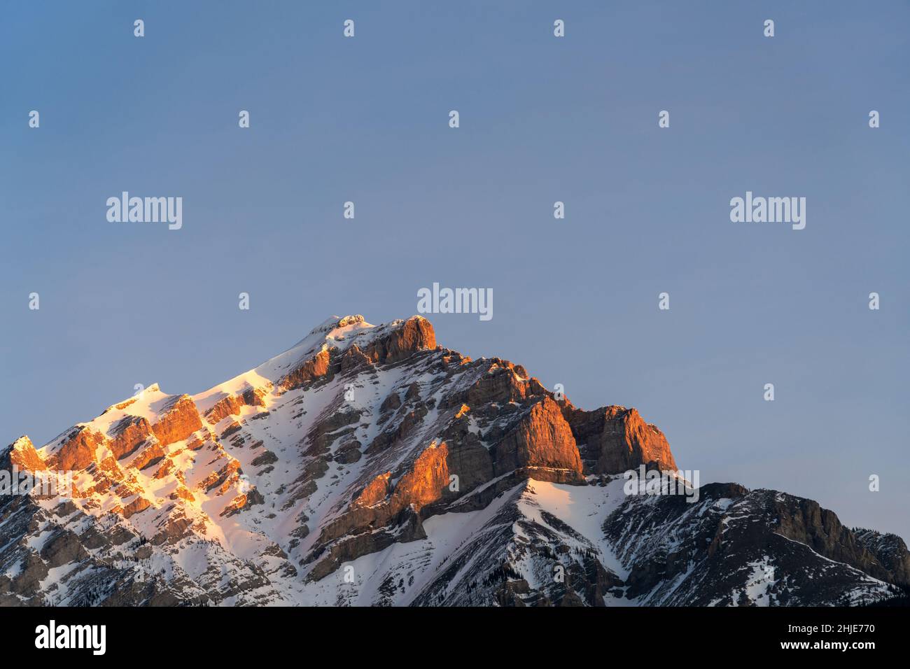 Snowcapped Cascade Mountain at dawn against clear sky. Banff National Park beautiful natural scenery. Canadian Rockies. Stock Photo