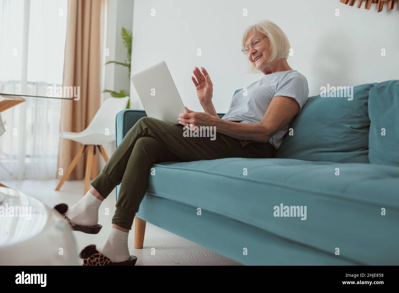 Older woman relaxing on sofa hi-res stock photography and images - Alamy