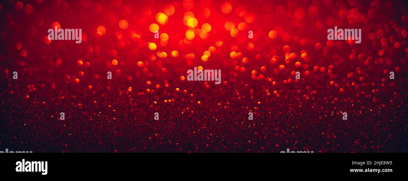 Red glitter texture with bokeh lights glowing in the dark Stock Photo
