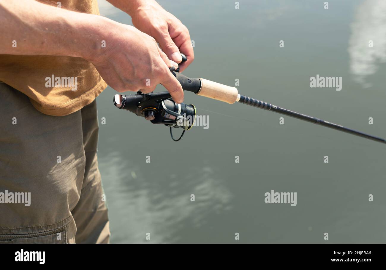 Hands holding fishing rod river hi-res stock photography and images - Alamy