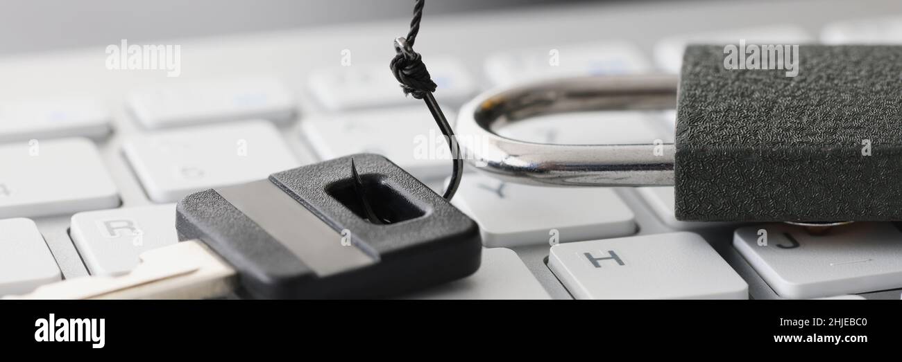 Key and lock on white computer keyboard closeup Stock Photo
