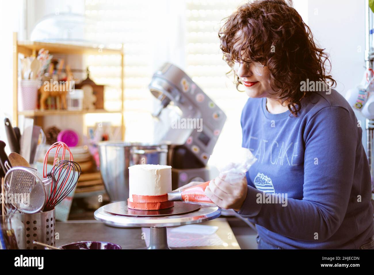 Caucasian woman preparing a cake. Baking at home. Selective focus. Stock Photo