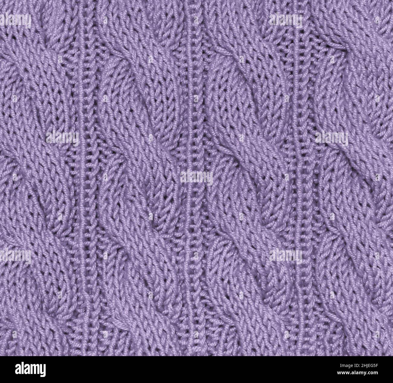 light purple knitted background from natural material. close-up surface, concept color of 2022. Stock Photo