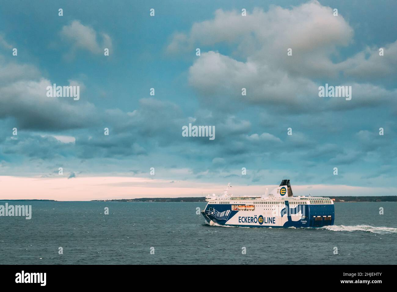 Helsinki, Finland. View Of Modern Ferry Ferryboat Viking Line Floating Near Blekholmen Valkosaari Island At Sunrise Sky. Stock Photo