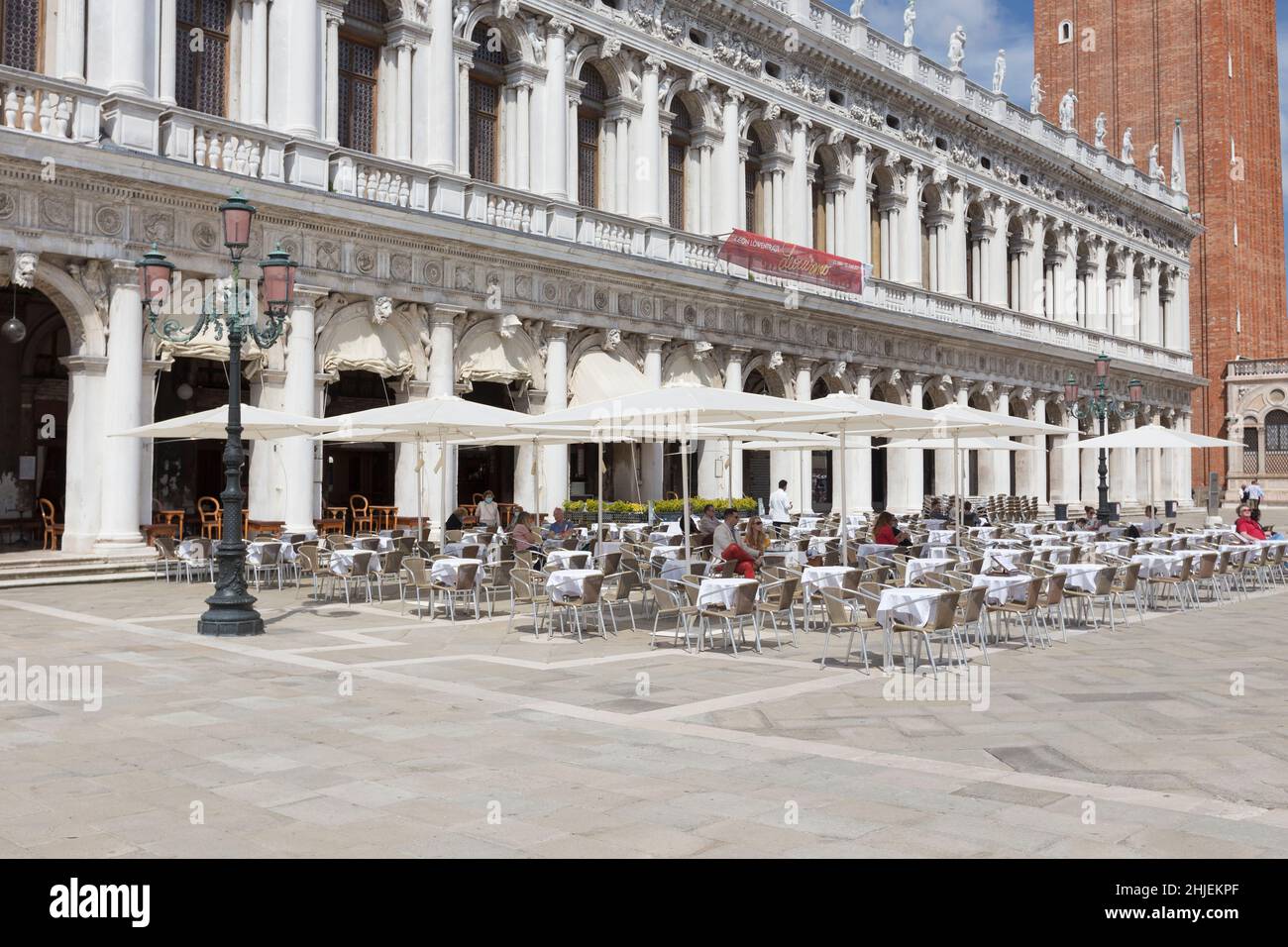 Tourists at Caffe Chioggia in St Mark's square, San Marco, Venice, Italy Stock Photo