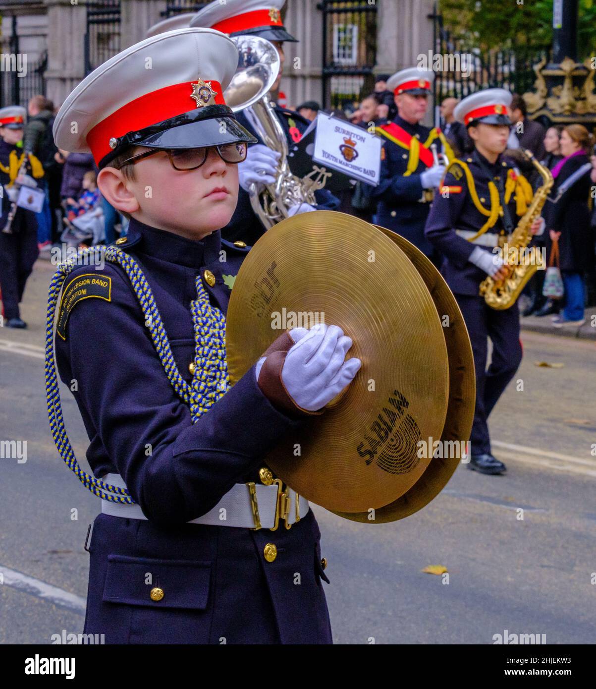 Young boy plays cymbals marching with the Surbiton Rbl Youth Marching Band at the Lord Mayor’s Show 2021, Victoria Embankment, London. Stock Photo