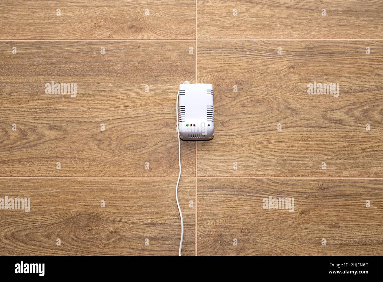 A carbon dioxide and gas sensor installed in a domestic boiler room on the wall, powered with 230 volts. Stock Photo