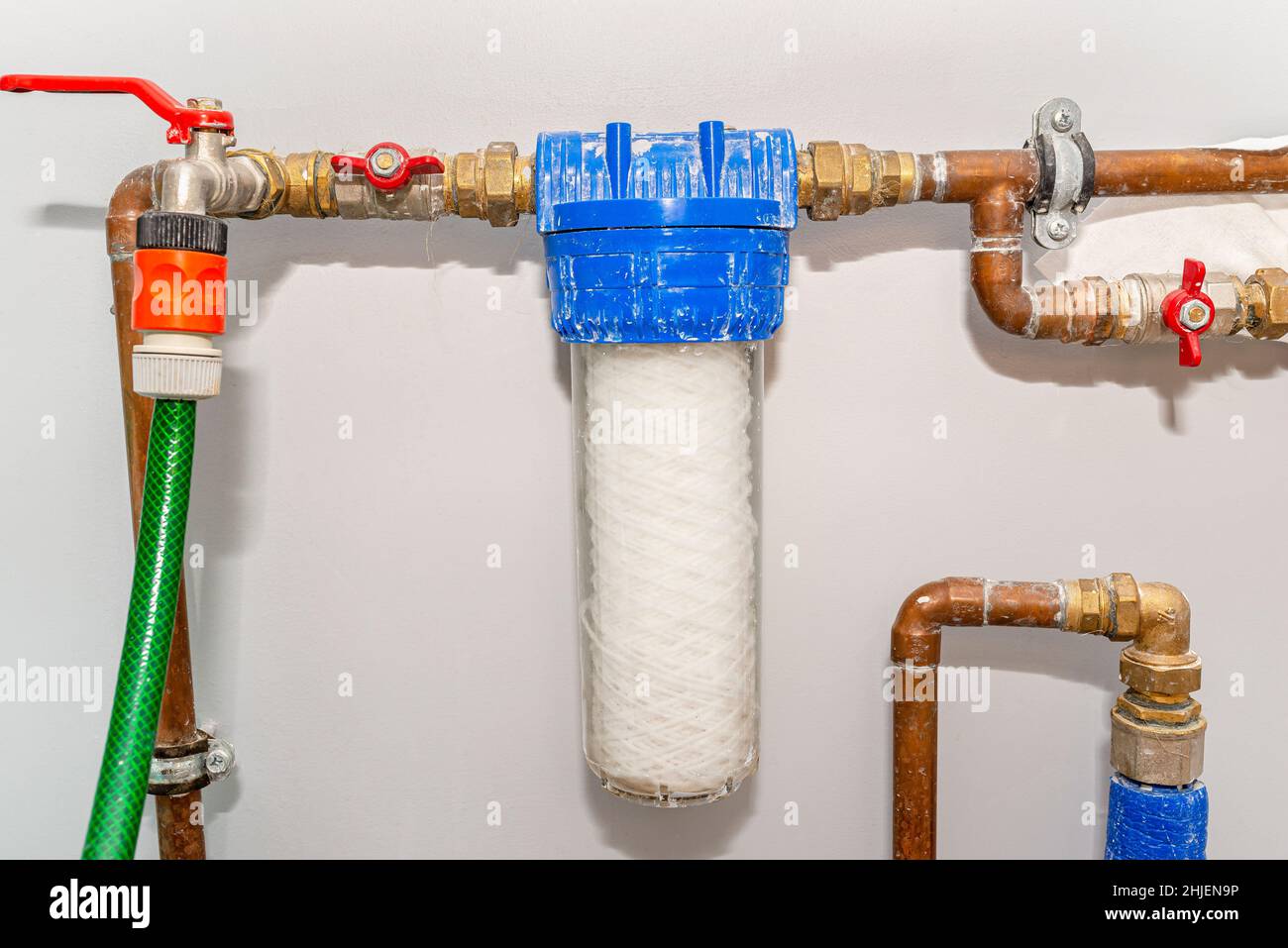 New 20 micron water string cartridge placed in front of the main water intake in the house. Stock Photo