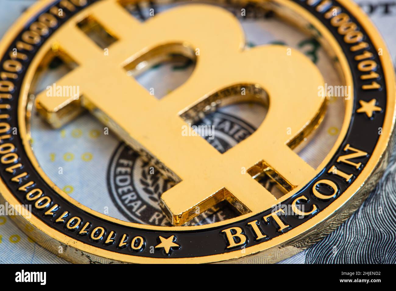 Bitcoin on 100 dollar bill background, gold coin of bitcoin on a hundred  dollar bill. Earnings on cryptocurrency mining Stock Photo - Alamy