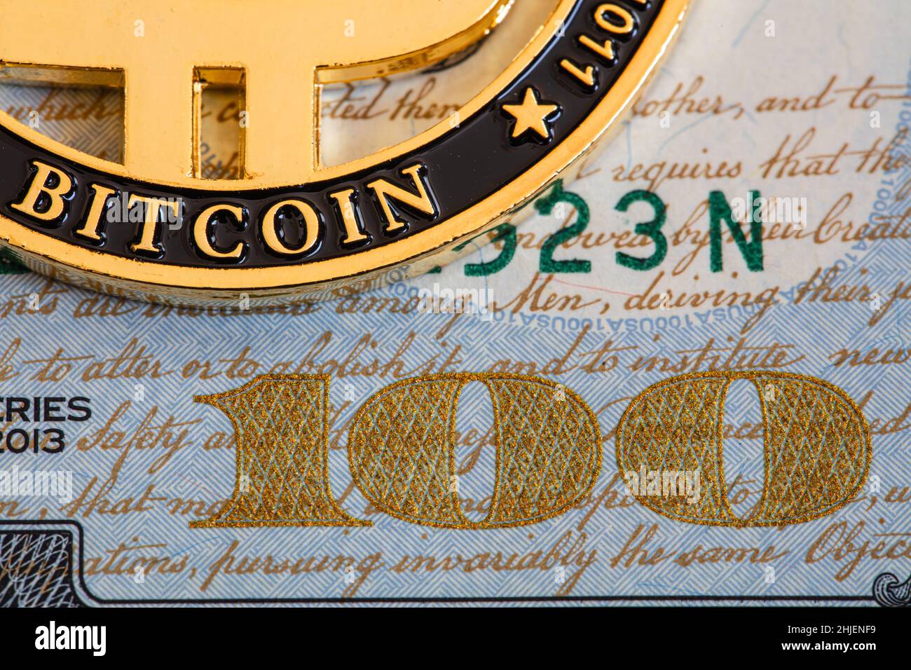 Bitcoin on 100 dollar bill background for design purpose Stock Photo - Alamy